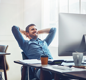 man in business casual attire sitting at computer