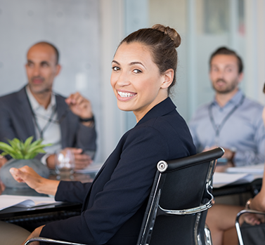 woman smiling at a table with others