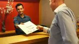 a man checking in at a concierge desk