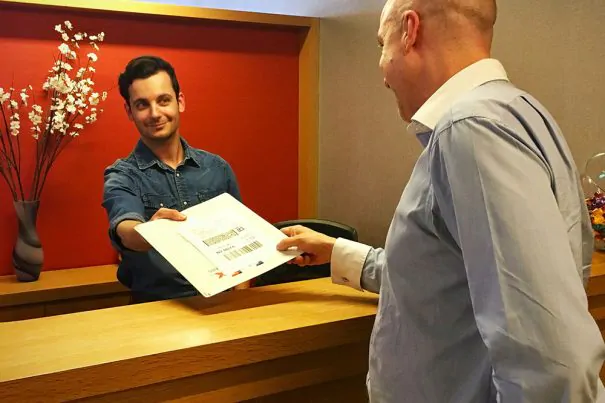 a man checking in at a concierge desk