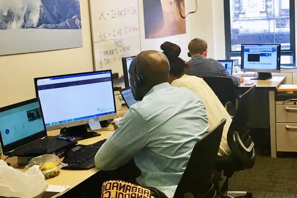a work space with 3 people working on computers